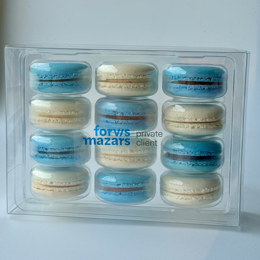 blue and white macarons in a 12 pack with company logo