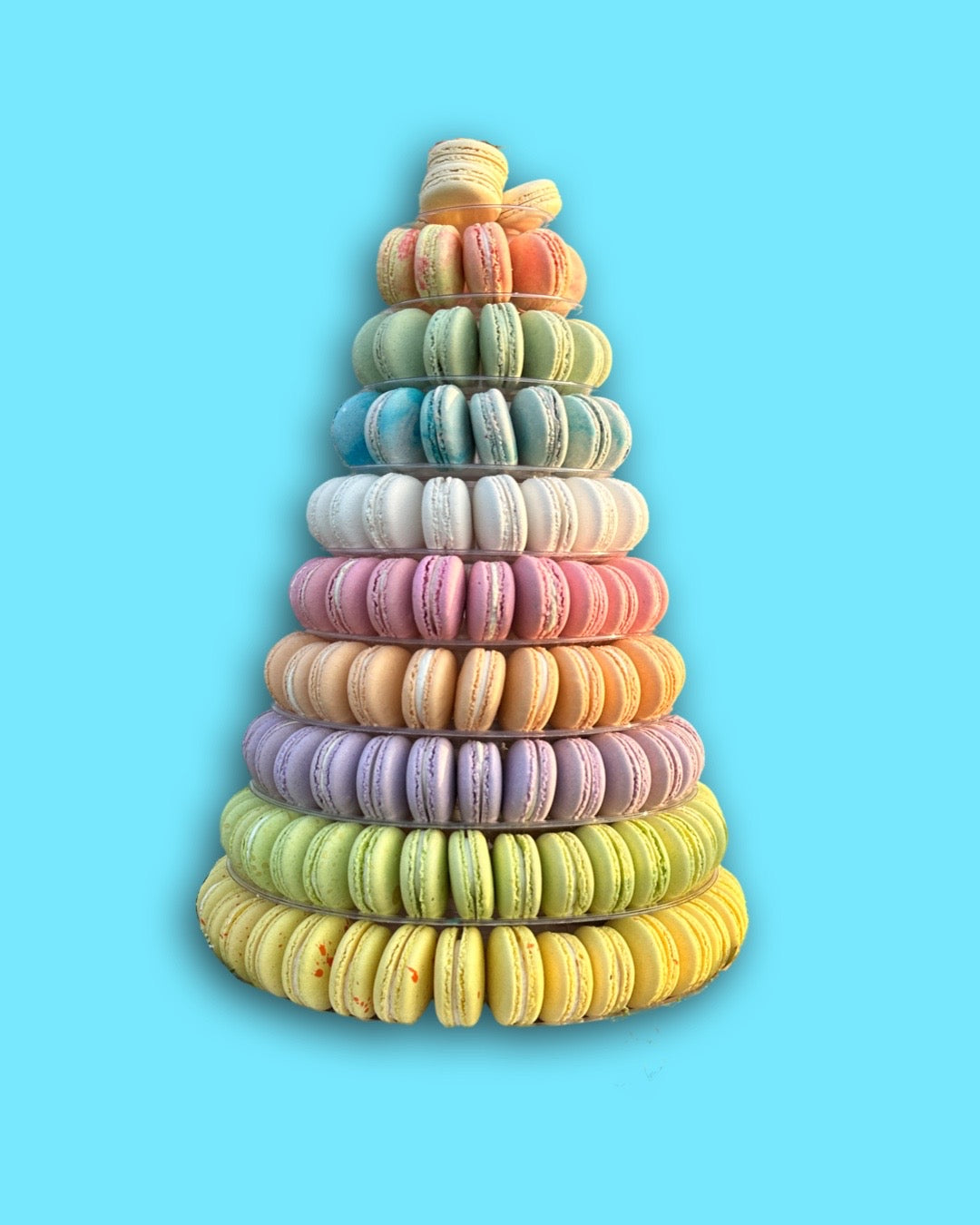 a ten tier tower of colorful macarons