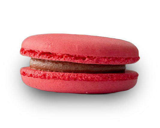 A single red macaron with a dark brown chocolate filling, shown against a plain white background with a soft drop shadow.
