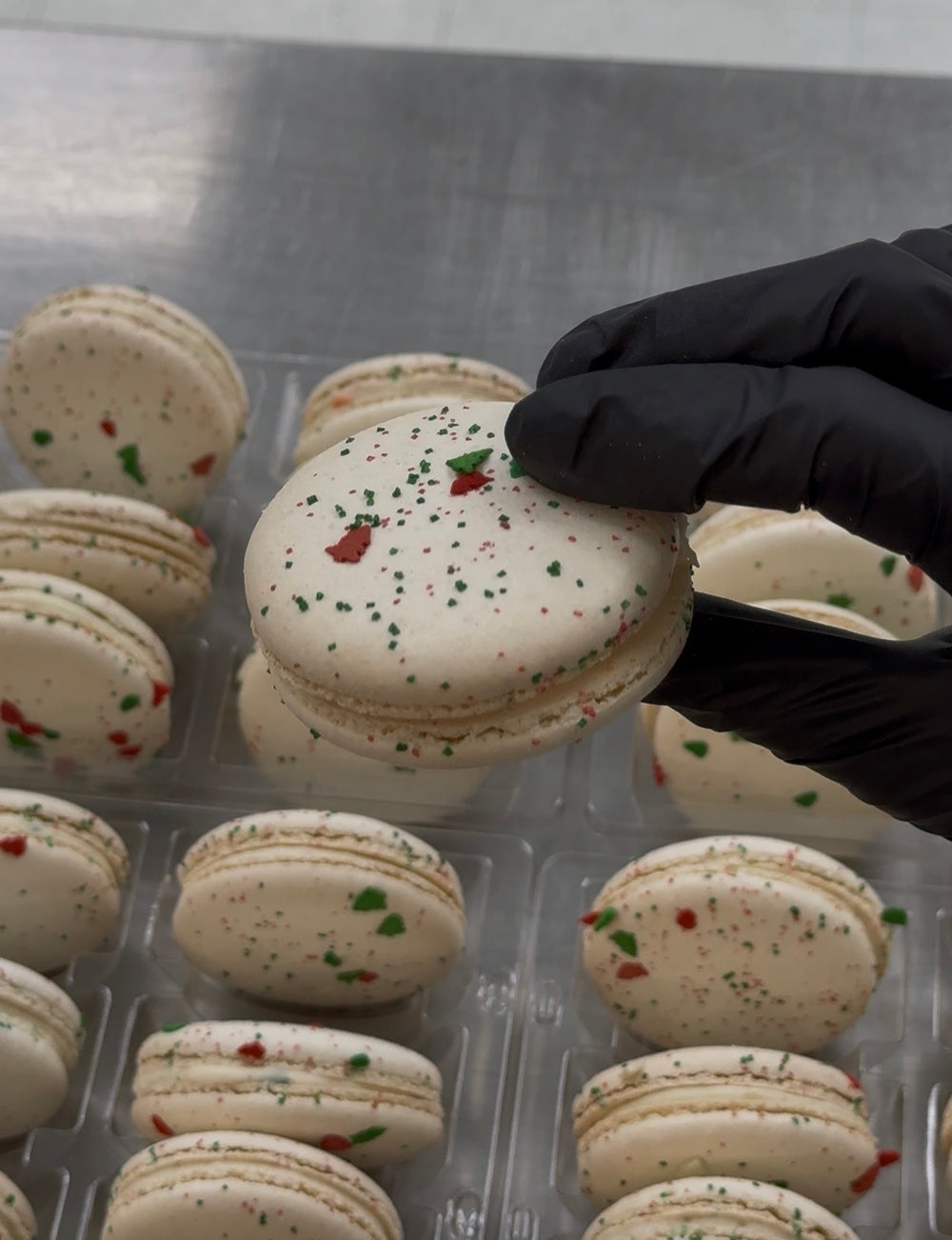 Extra large white french macarons with red and green sprinkles