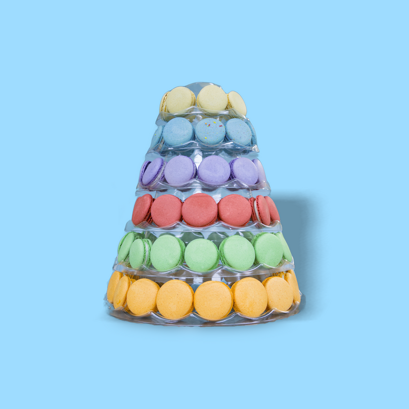 A tower of colorful macarons on a blue background