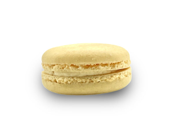 Side profile of salted caramel French macaron