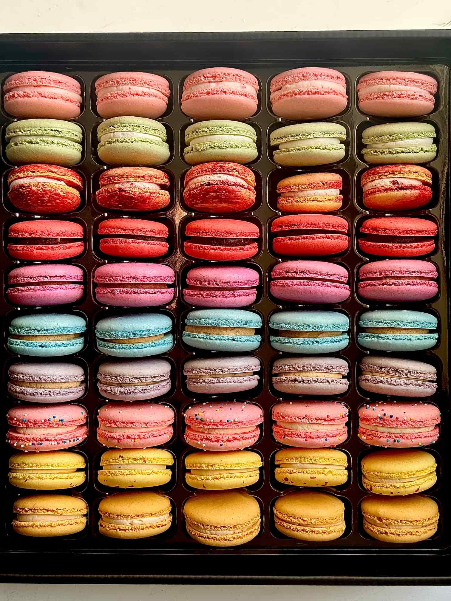 50 pack of colorful french macarons overhead