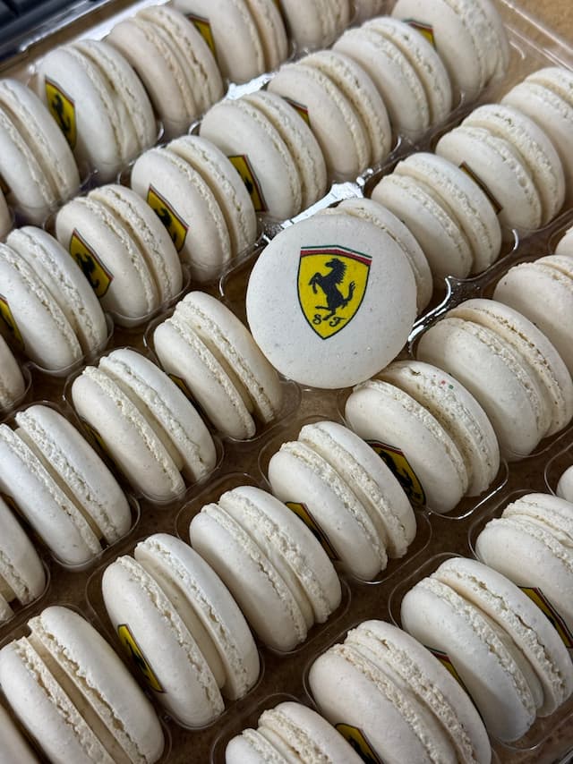 white macarons with a ferrari logo printed on them