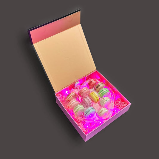 pink and gold box with pink LED lighting and a heart shaped 12 pack of french macarons